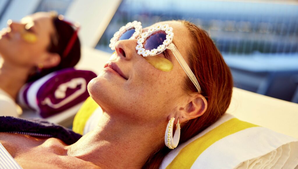 woman sunbathing Virgin Voyages ship