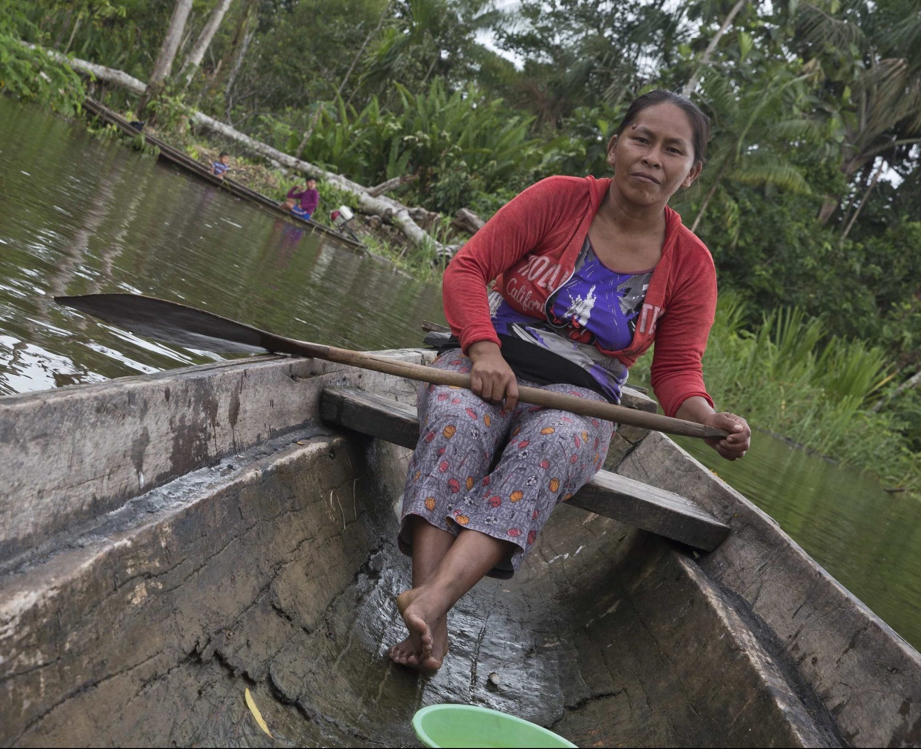 Tribeswoman in boat on Amazon River