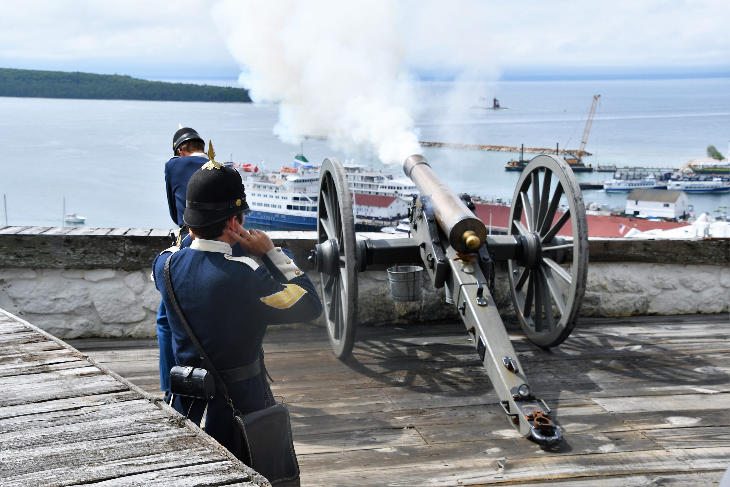 The-daily-cannon-firing-at-Fort-Mackinac-with-Ocean-Voyager-in-the-background